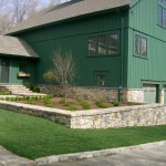 Newly planted landscape beds and fresh sod compliment newly completed stone work.