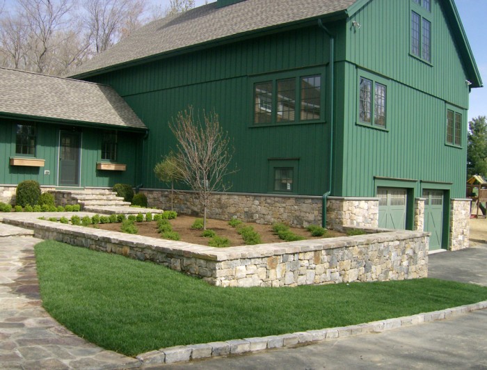 Newly planted landscape beds and fresh sod compliment newly completed stone work.