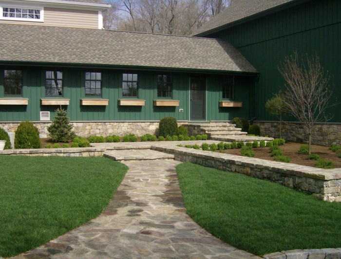 Side entrance with newly planted landscaping and sod.